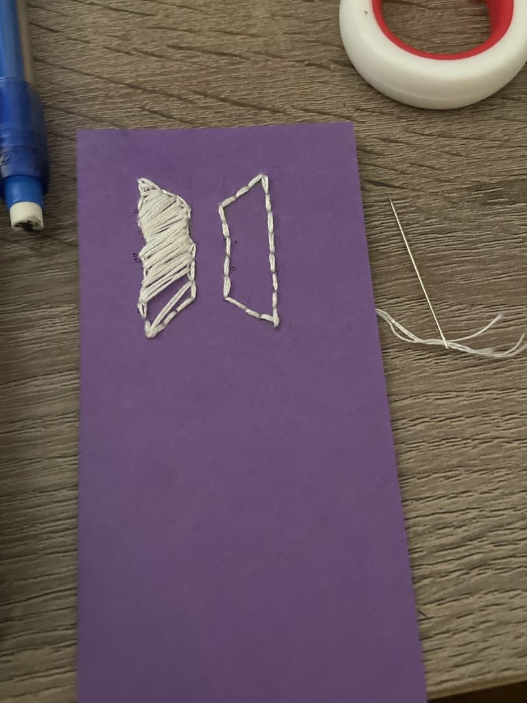 My first attempt at a BTS-themed bookmark with white embroidery floss on purple paper.
