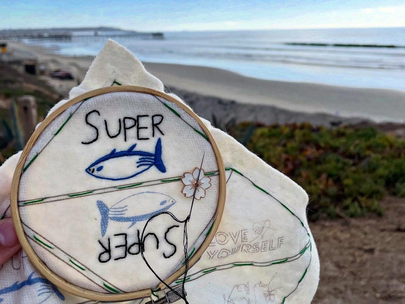 Super Tuna bookmark embroidery work in progress on a beach in California.