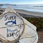 Super Tuna bookmark embroidery work in progress on a beach in California.
